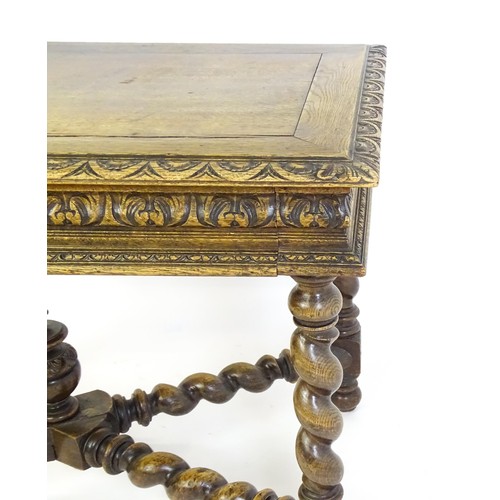 1548 - A late 19thC oak side table with a carved outer rim and single long drawer raised on barley twist le... 