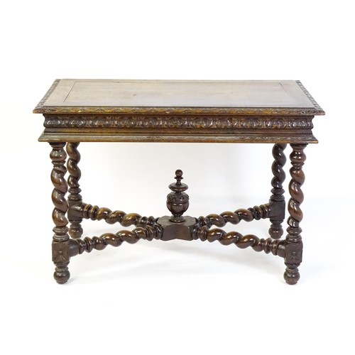 1548 - A late 19thC oak side table with a carved outer rim and single long drawer raised on barley twist le... 