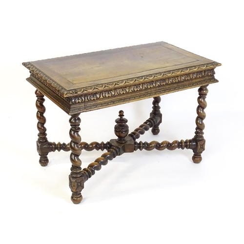 1548 - A late 19thC oak side table with a carved outer rim and single long drawer raised on barley twist le... 