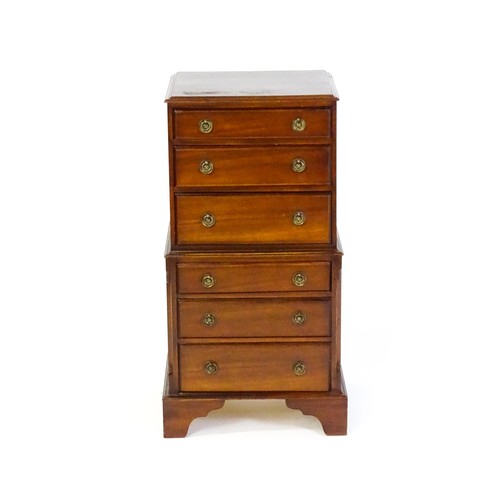 1549 - A 20thC mahogany chest on chest of small proportions, the structure containing six short drawers and... 