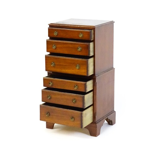 1549 - A 20thC mahogany chest on chest of small proportions, the structure containing six short drawers and... 