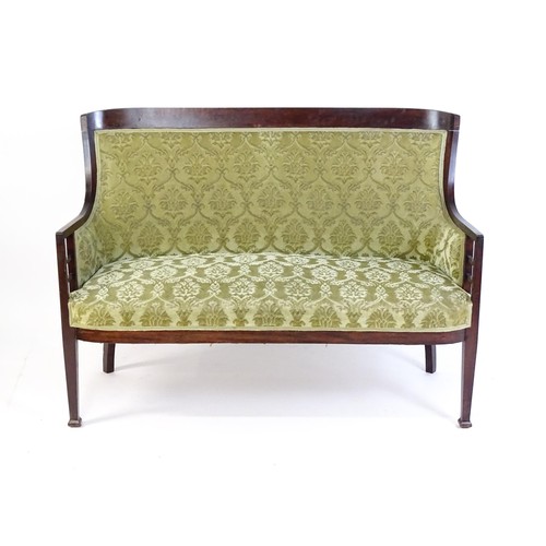 1550 - A late 19thC / early 20thC sofa in the Aesthetic style, with a shaped backrest, bracketed supports t... 