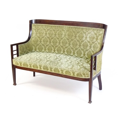 1550 - A late 19thC / early 20thC sofa in the Aesthetic style, with a shaped backrest, bracketed supports t... 