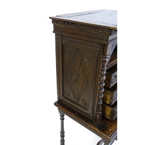 1552 - A Victorian oak cabinet on stand. A 19thC table cabinet with carved lozenge decoration , six short d... 