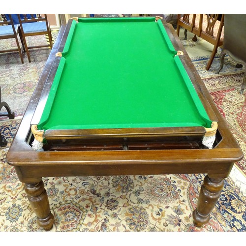 1559 - A 20thC oak combination dining / snooker table, with revolving mechanism and slate base, approx 84 1... 