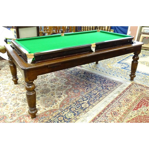 1559 - A 20thC oak combination dining / snooker table, with revolving mechanism and slate base, approx 84 1... 