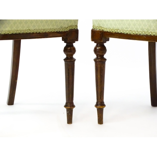 1609 - A pair of Edwardian walnut side chairs with carved cresting rails, pierced floral back splats and ra... 