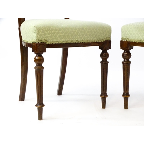 1609 - A pair of Edwardian walnut side chairs with carved cresting rails, pierced floral back splats and ra... 