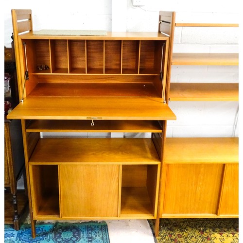 1622 - A mid 20thC Ladderax teak modular shelving system, comprising two cupboards, one with full length gl... 