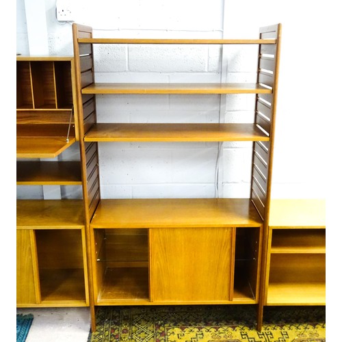 1622 - A mid 20thC Ladderax teak modular shelving system, comprising two cupboards, one with full length gl... 