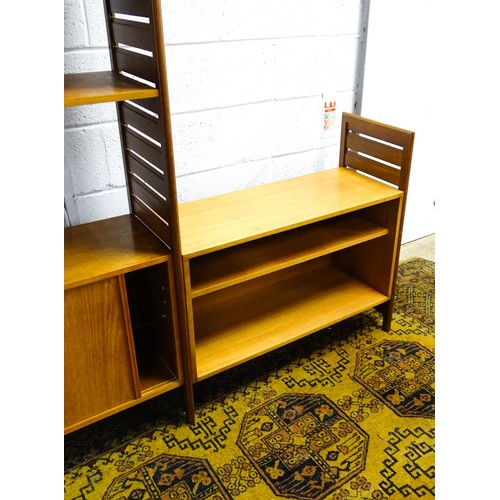 1622 - A mid 20thC Ladderax teak modular shelving system, comprising two cupboards, one with full length gl... 