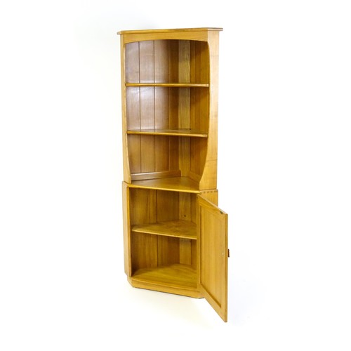 1628 - Vintage / Retro: An elm Ercol Windsor corner cabinet with a moulded cornice above three shelves and ... 