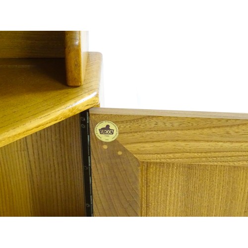 1628 - Vintage / Retro: An elm Ercol Windsor corner cabinet with a moulded cornice above three shelves and ... 