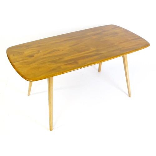 1631 - Vintage / Retro: An Ercol dining table with an oblong elm top above four tapering splayed legs. Bear... 