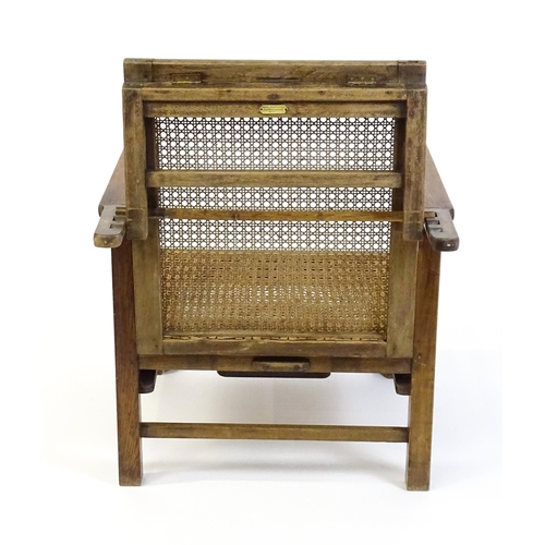 1455 - A late 19thC / early 20hC teak plantation chair / steamer chair, with an adjustable caned backrest, ... 