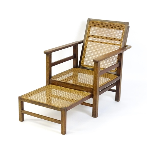 1455 - A late 19thC / early 20hC teak plantation chair / steamer chair, with an adjustable caned backrest, ... 