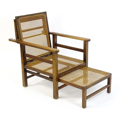 1455 - A late 19thC / early 20hC teak plantation chair / steamer chair, with an adjustable caned backrest, ... 