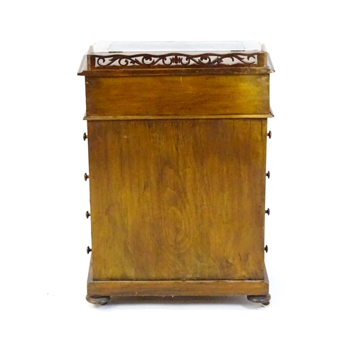 1543 - A 19thC walnut Davenport, with a pierced upstand, a writing slope and four short drawers opposing fo... 