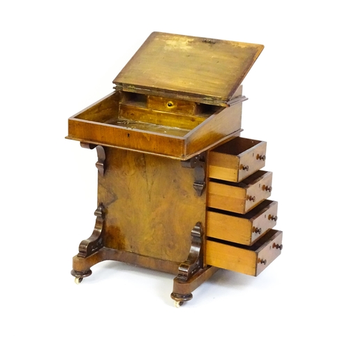 1543 - A 19thC walnut Davenport, with a pierced upstand, a writing slope and four short drawers opposing fo... 