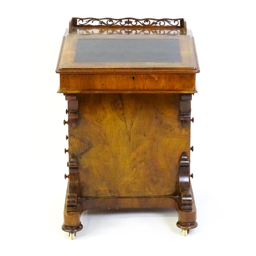 1543 - A 19thC walnut Davenport, with a pierced upstand, a writing slope and four short drawers opposing fo... 