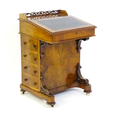 1543 - A 19thC walnut Davenport, with a pierced upstand, a writing slope and four short drawers opposing fo... 