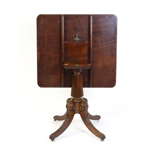 1545 - A 19thC mahogany occasional table, with a reeded tapering pedestal and raised on four reeded legs wi... 