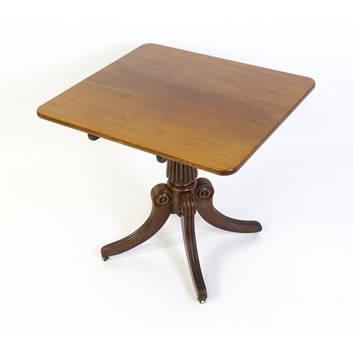 1545 - A 19thC mahogany occasional table, with a reeded tapering pedestal and raised on four reeded legs wi... 