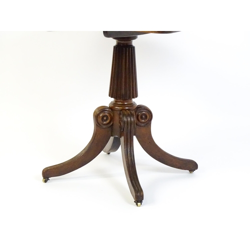 1545 - A 19thC mahogany occasional table, with a reeded tapering pedestal and raised on four reeded legs wi... 