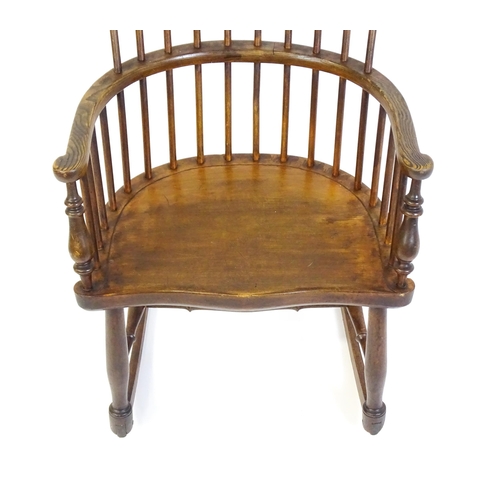 1546 - A mid 19thC ash and sycamore Windsor rocking chair, with a bowed top rail, tuned spindles and a shap... 