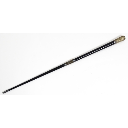 1118 - An early 20thC ebonised conductor's baton of tapering form with silver mounts engraved with foliate ... 