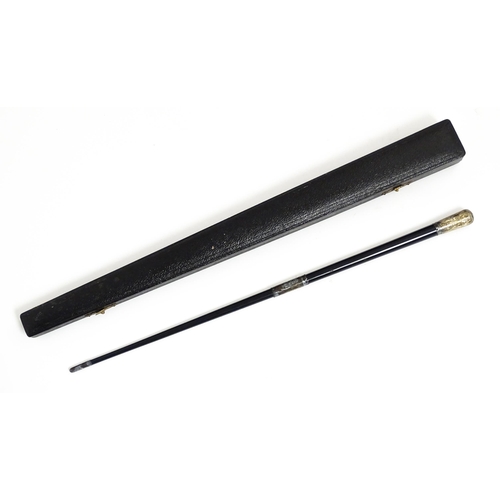 1118 - An early 20thC ebonised conductor's baton of tapering form with silver mounts engraved with foliate ... 