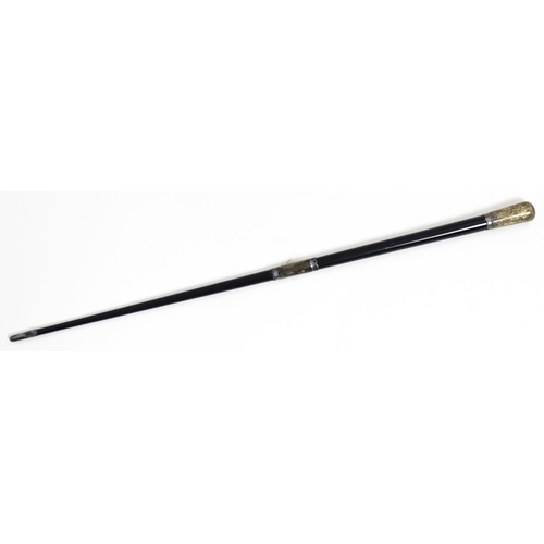 1118 - An early 20thC ebonised conductor's baton of tapering form with silver mounts engraved with foliate ... 