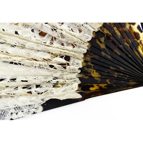 1119 - An early 20thC black feather fan with 20 faux tortoiseshell sticks. Together with another smaller ex... 