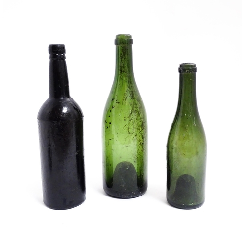 1151 - Three 19thC glass wine bottles. Largest approx 12