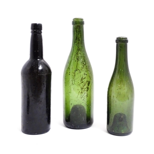 1151 - Three 19thC glass wine bottles. Largest approx 12