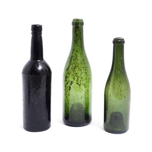 1151 - Three 19thC glass wine bottles. Largest approx 12