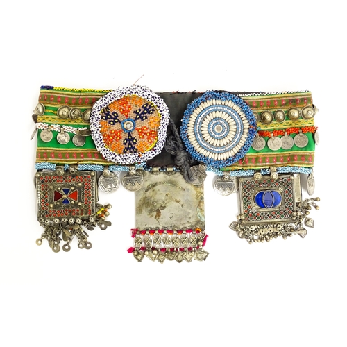 1154 - An Eastern dance belt decorated with banded stud, bead, and coin detail, with decorative plaques low... 