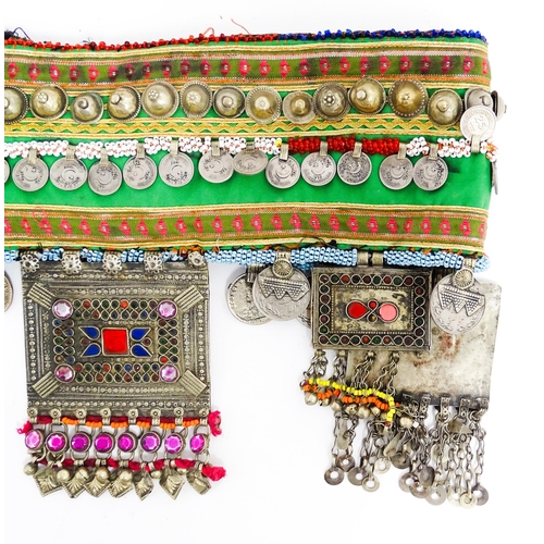 1154 - An Eastern dance belt decorated with banded stud, bead, and coin detail, with decorative plaques low... 