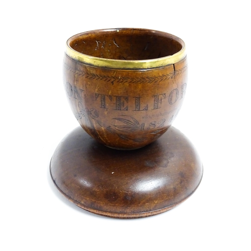 1158 - A 19thC polished coconut cup with brass rim and engraved swag and bow detail, titled William Pattiso... 
