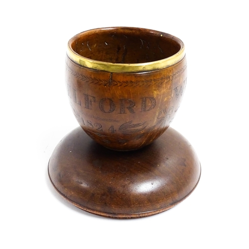 1158 - A 19thC polished coconut cup with brass rim and engraved swag and bow detail, titled William Pattiso... 