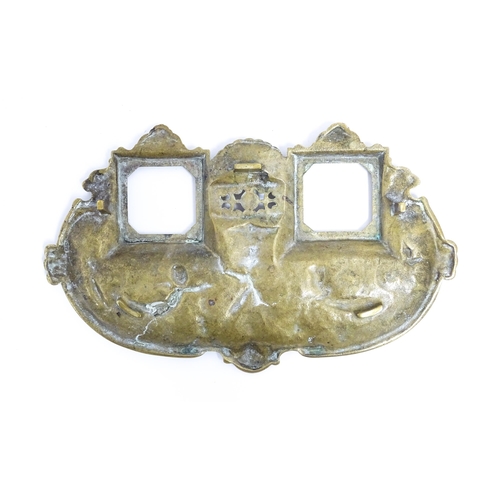 1170 - A late 19th / early 20thC cast brass standish with mask, cherub, shell and swag detail, with two gla... 