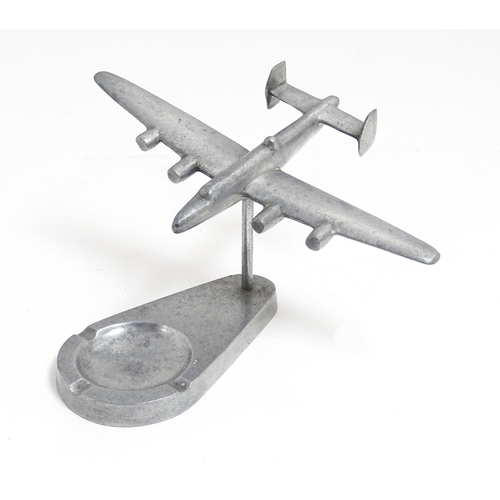 1173 - A 20thC cast ashtray surmounted by a model of an aeroplane. Approx. 4 3/4