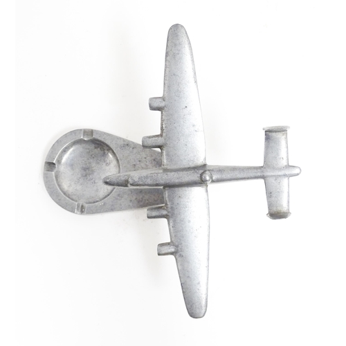 1173 - A 20thC cast ashtray surmounted by a model of an aeroplane. Approx. 4 3/4