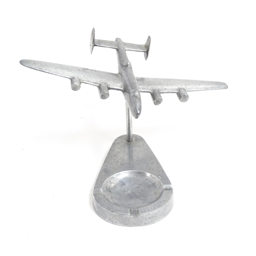 1173 - A 20thC cast ashtray surmounted by a model of an aeroplane. Approx. 4 3/4