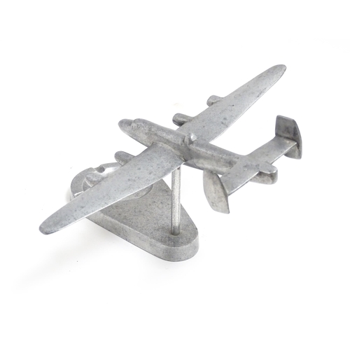 1173 - A 20thC cast ashtray surmounted by a model of an aeroplane. Approx. 4 3/4