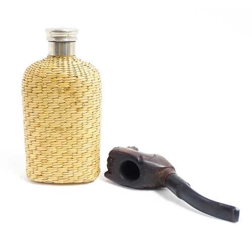 1176 - An early 20thC hip flask with rattan woven cover. Together with a carved novelty tobacco pipe, the b... 