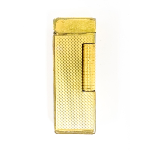 1177 - A Dunhill Rollagas lighter with chequered finish. Together with an Oriental enamelled aide de memoir... 