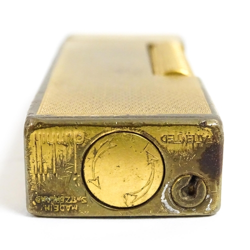 1177 - A Dunhill Rollagas lighter with chequered finish. Together with an Oriental enamelled aide de memoir... 