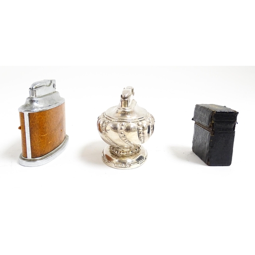 1179 - A Ronson Senator table lighter. Together with a Ronson Crown table lighter and a vanity case vesta c... 