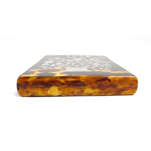 1188 - A Victorian tortoiseshell card case of rectangular form with inlaid mother of pearl floral and folia... 